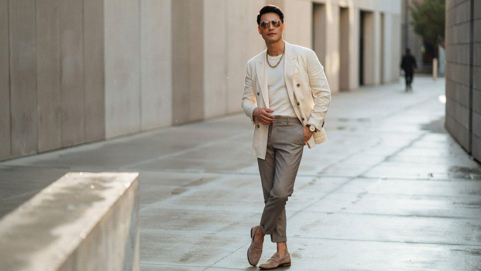 "Man wearing retro accessories like aviator sunglasses and vintage watch in a modern 80s-inspired fashion look"