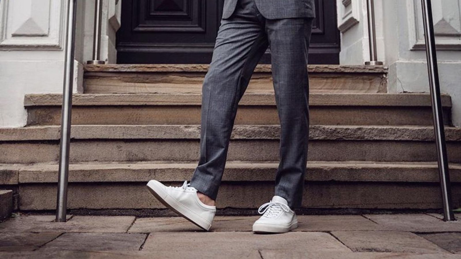 A person wearing white sneakers showcasing a trendy and modern look
