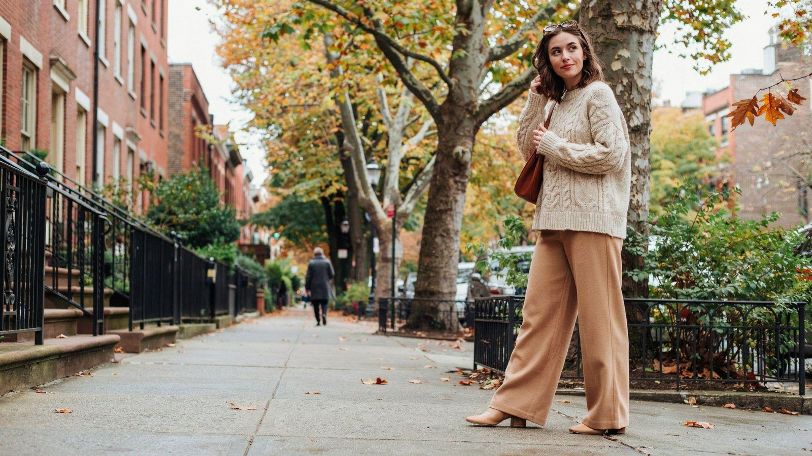 "Woman styling wide leg pants with a cozy oversized sweater for a casual fall outfit"