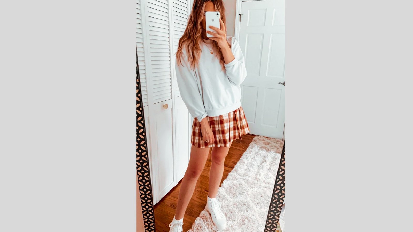 Plaid skort worn with a crewneck sweatshirt