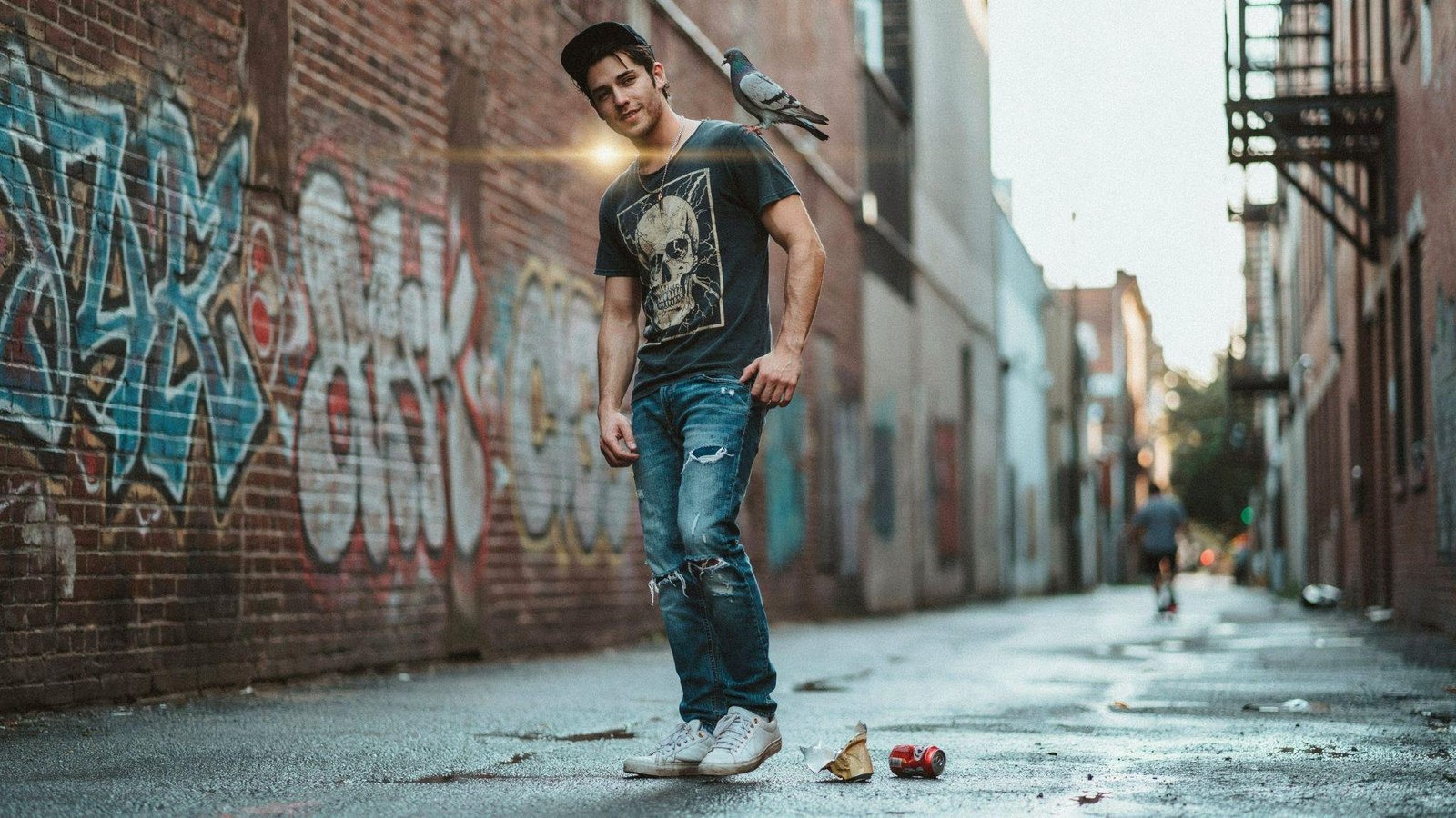 "Man wearing vintage band tee with distressed denim jeans and casual 80s rock-inspired streetwear style"