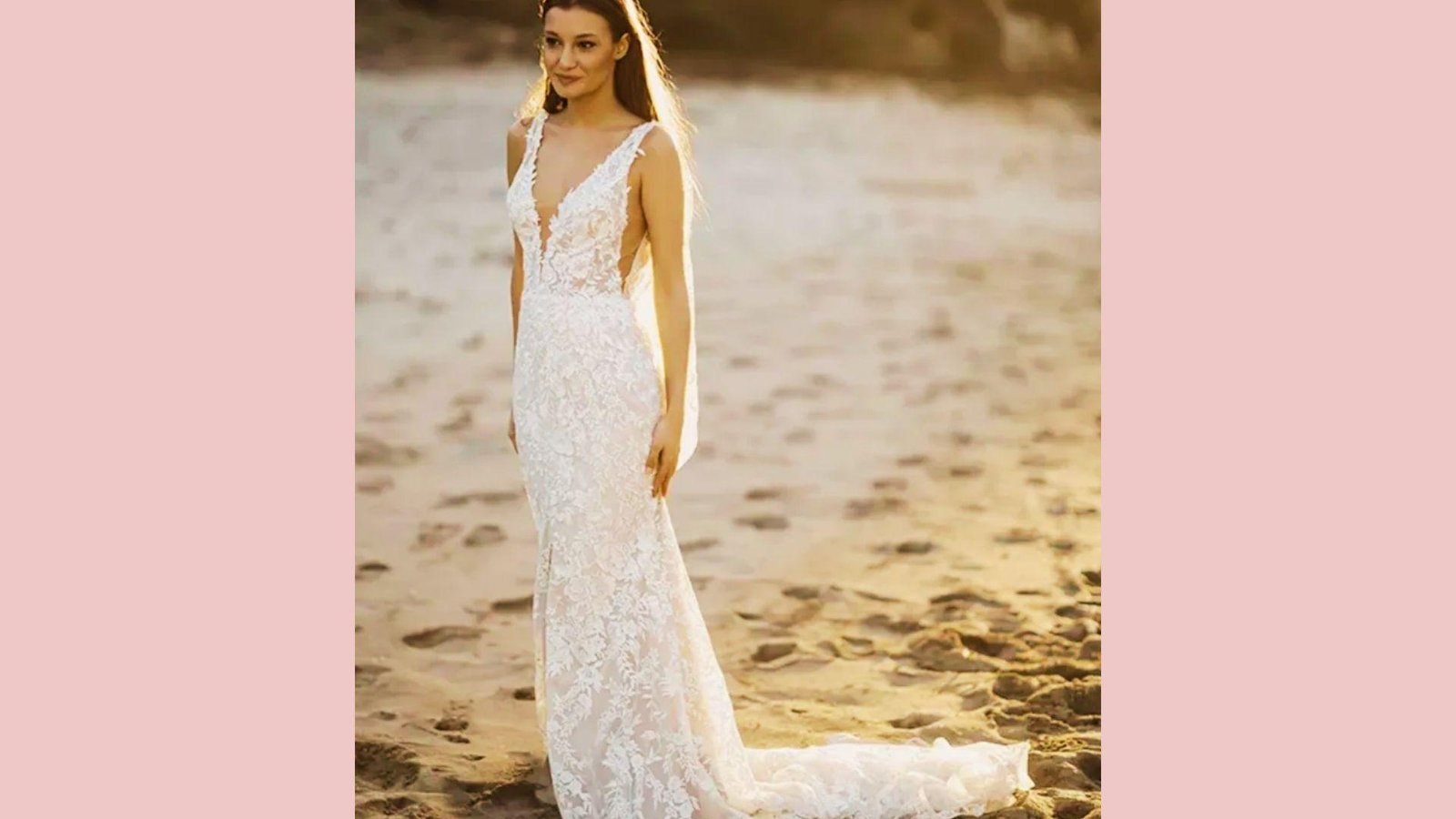 Bride in all-over lace sheath gown with deep V-neckline, side cutouts, spaghetti straps, train, standing on beach