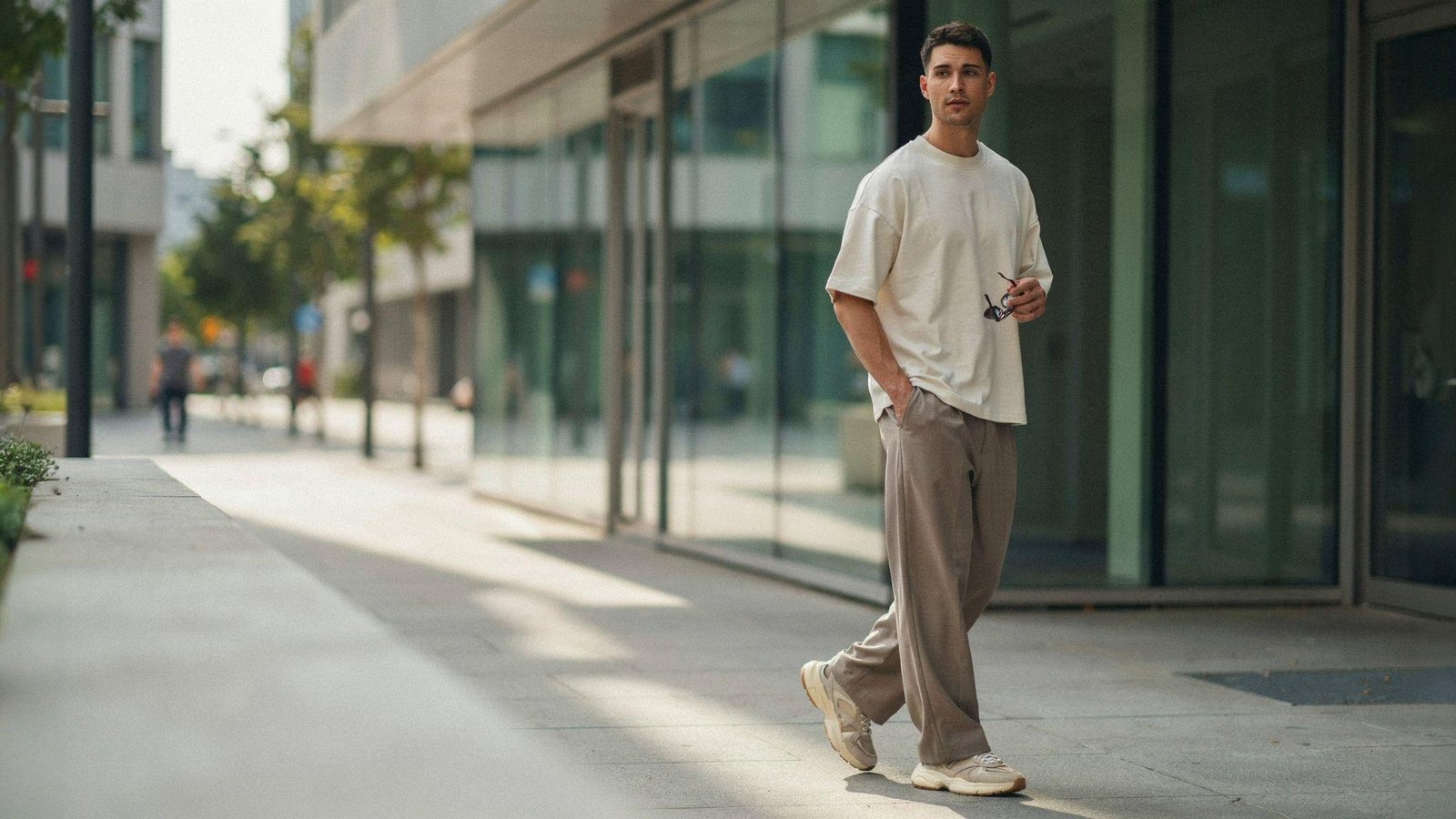 "Man wearing relaxed outfit with chunky sneakers in modern 80s-inspired streetwear style"