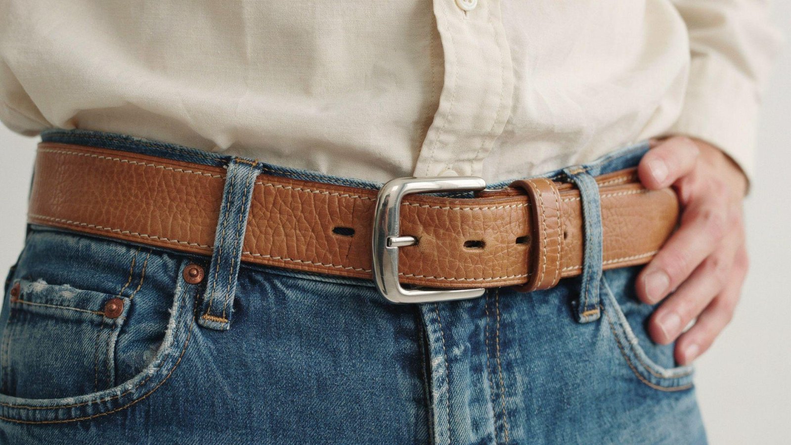"Stylish men's and women's outfits featuring modern and vintage belt buckles with detailed fashion styling"