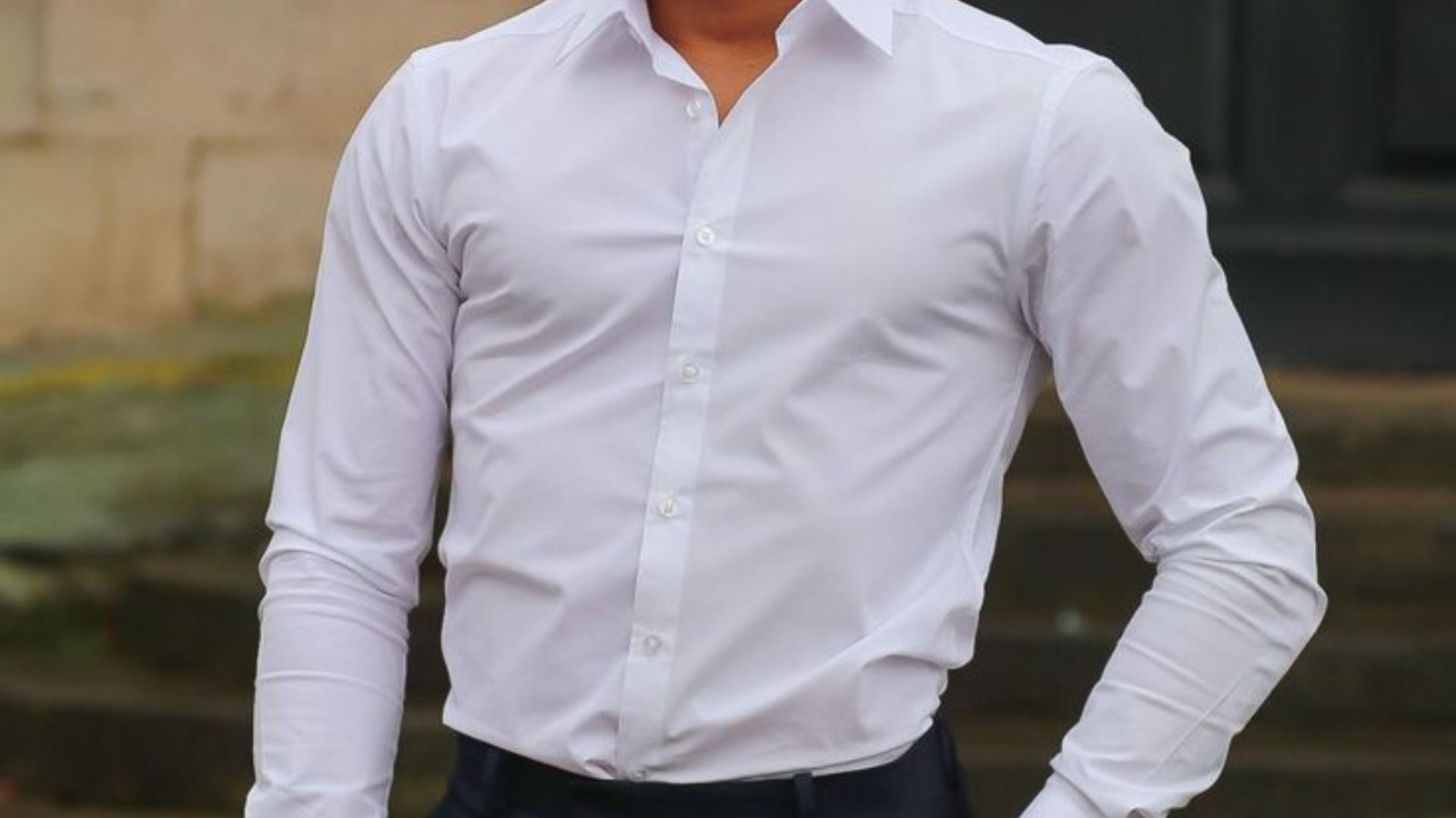 A man in a white shirt paired with black pants, representing a classic and timeless look