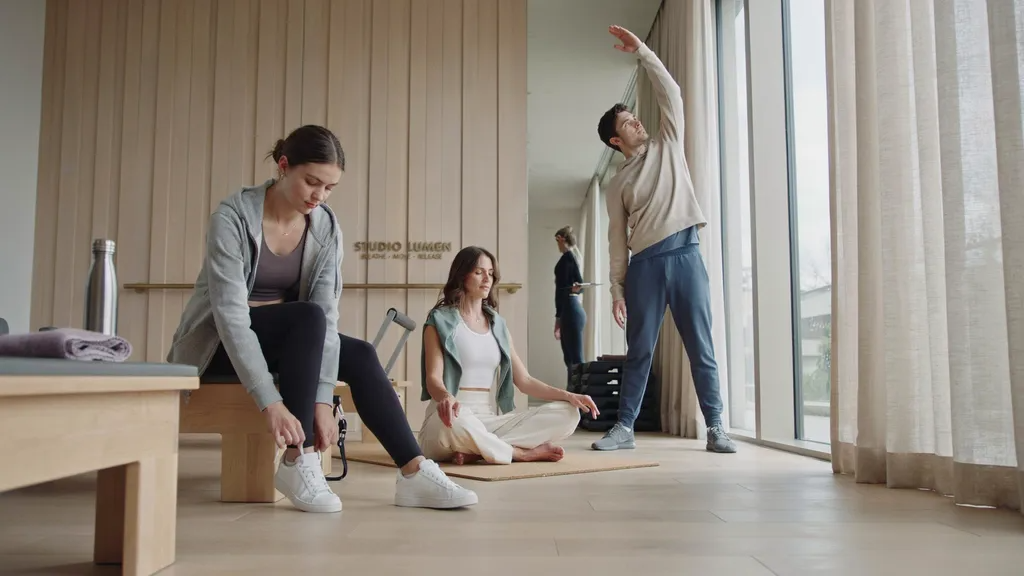 Pilates warm-up with light hoodies and activewear in the studio.