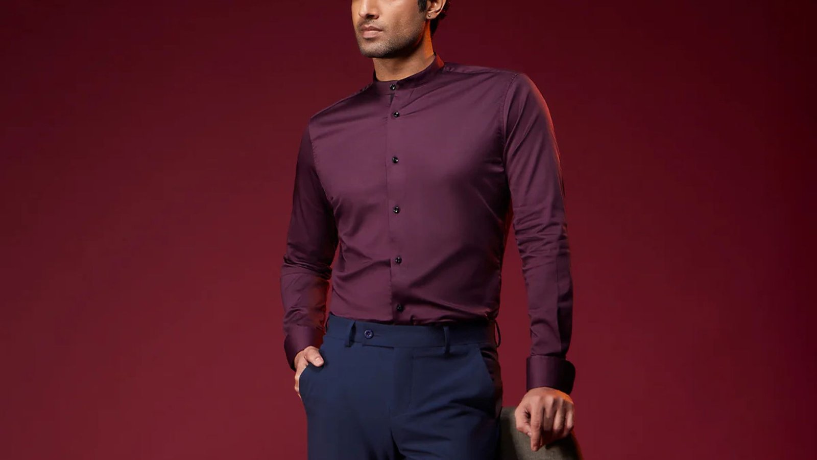 A man wearing a burgundy colored shirt, showcasing a rich and contrasting look.