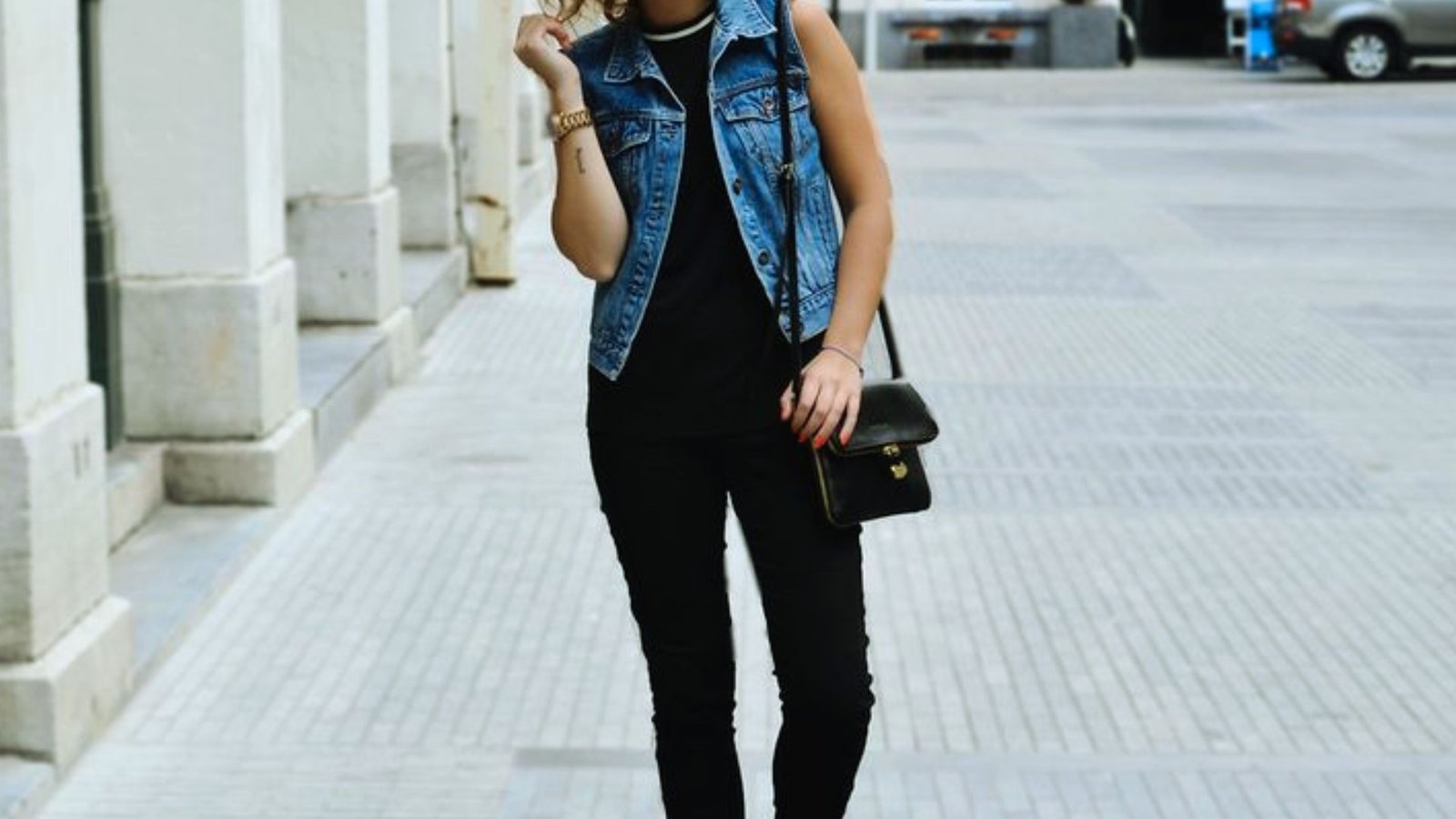 Denim vest paired with black jeans for an everyday casual look.