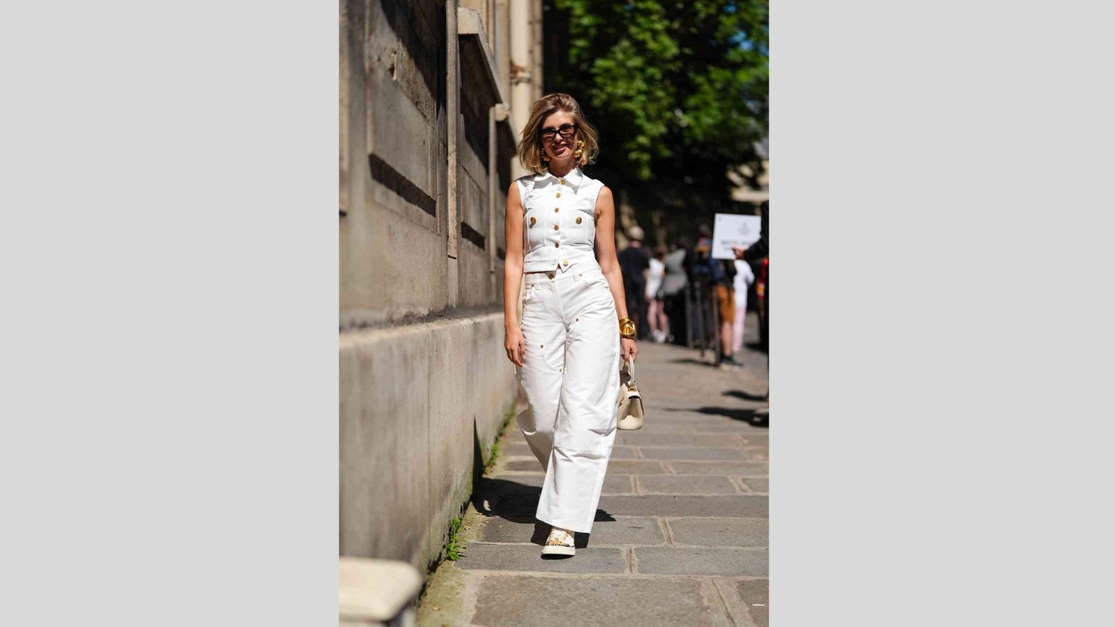 All-white outfit featuring a white denim vest and trousers.
